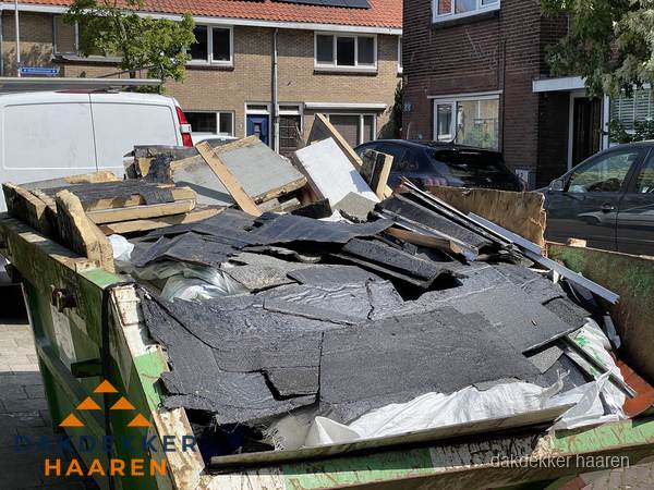 Afvalcontainer met gesloopt dakmateriaal tijdens dakkapel renovatie in Haaren Afvalcontainer met gesloopt dakmateriaal tijdens dakkapel renovatie in Haaren